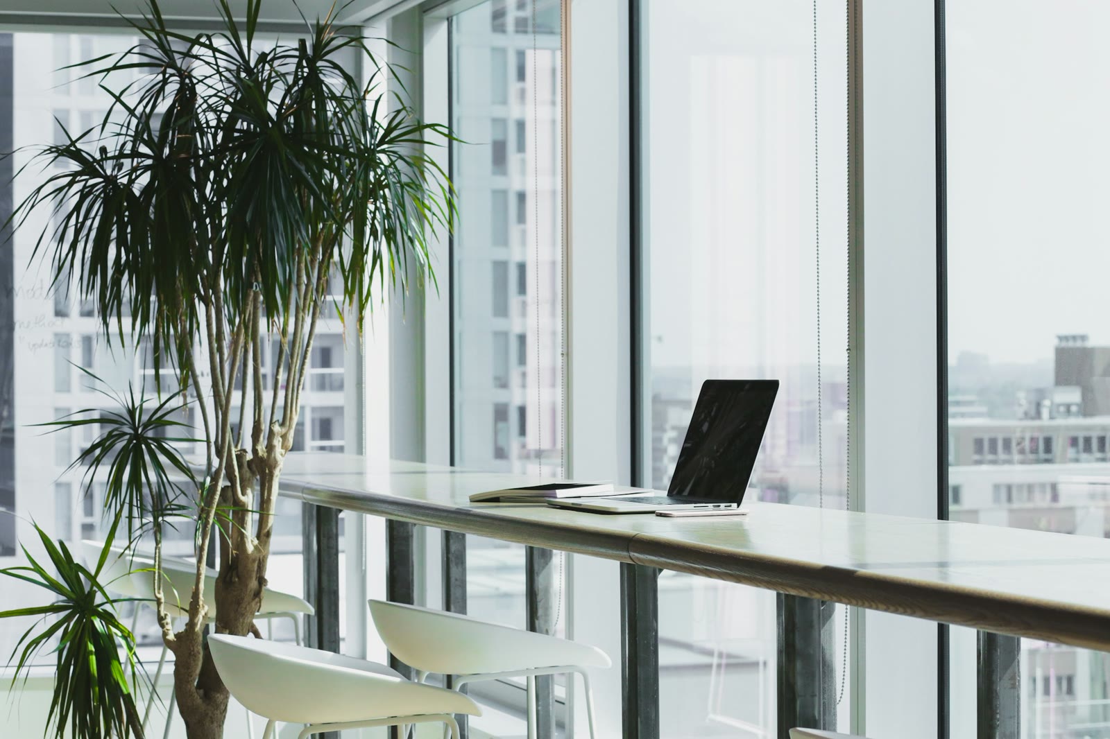 Modern tech workplace with laptop and city view