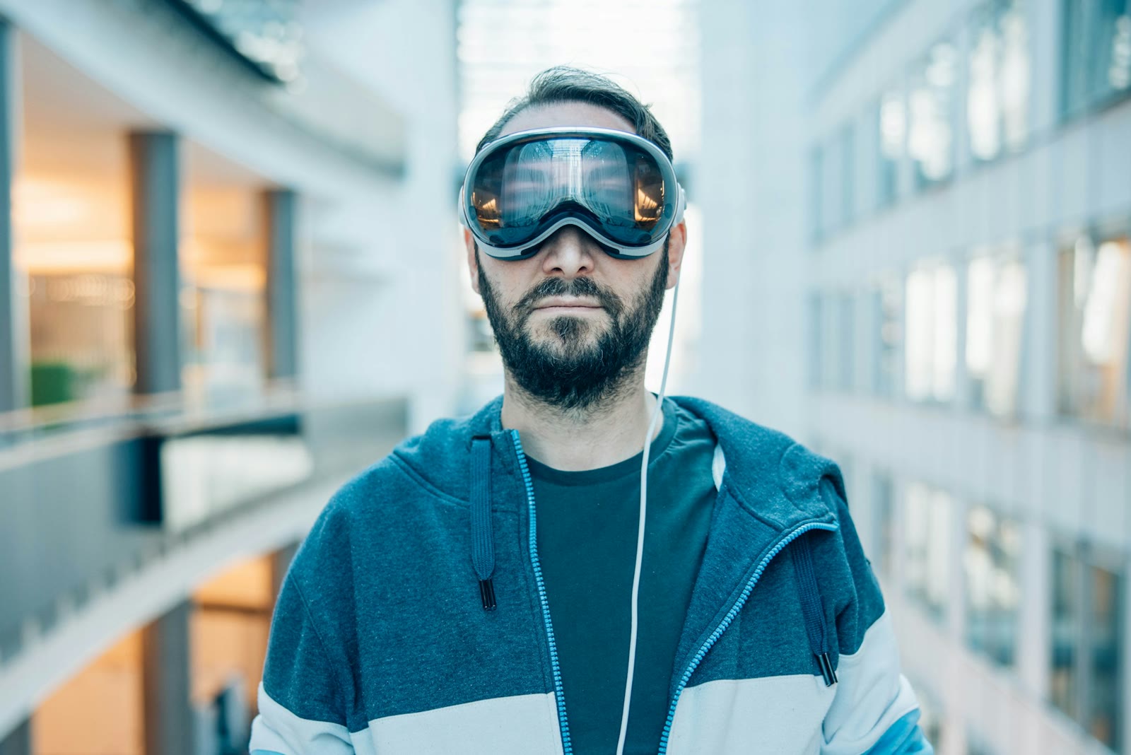 Person wearing a spatial headset in a modern atrium